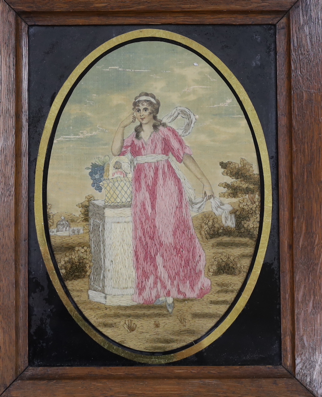 Two framed Regency silk and wool-worked religious panels, one of Mary and baby Jesus and the other of a lady in a garden by a pillar, largest 27cm wide x 31cm high